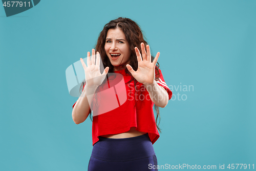 Image of Portrait of the scared woman on blue