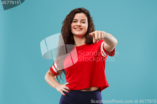 Image of The happy business woman point you and want you, half length closeup portrait on blue background.