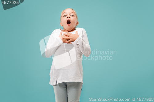 Image of Beautiful teen girl looking suprised isolated on blue