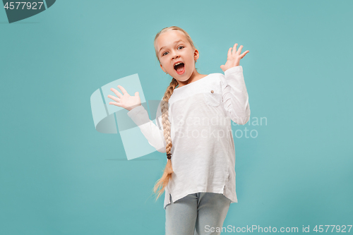 Image of Beautiful teen girl looking suprised isolated on blue