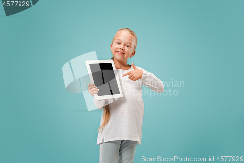 Image of Little funny girl with tablet on blue background