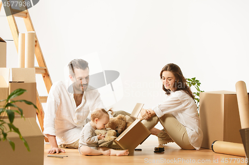 Image of Couple moving to a new home - Happy married people buy a new apartment to start new life together