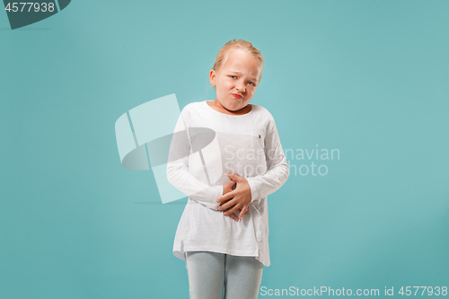 Image of Young woman overwhelmed with a pain in the stomach .