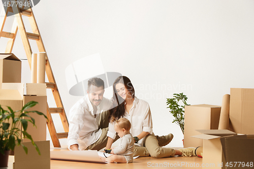 Image of Couple moving to a new home - Happy married people buy a new apartment to start new life together