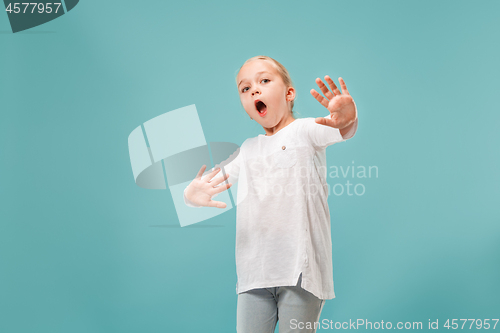 Image of Portrait of the scared girl on blue