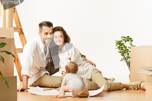 Image of Couple moving to a new home - Happy married people buy a new apartment to start new life together