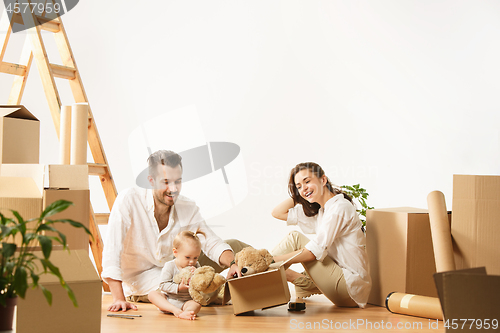 Image of Couple moving to a new home - Happy married people buy a new apartment to start new life together