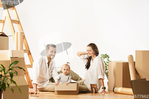 Image of Couple moving to a new home - Happy married people buy a new apartment to start new life together