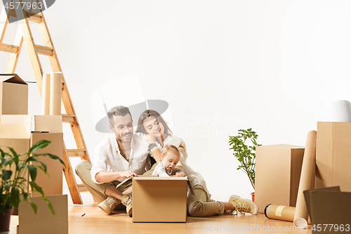 Image of Couple moving to a new home - Happy married people buy a new apartment to start new life together