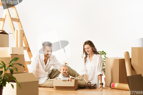 Image of Couple moving to a new home - Happy married people buy a new apartment to start new life together