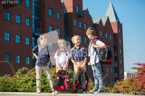 Image of A group of children of school and preschool age are standing against sity