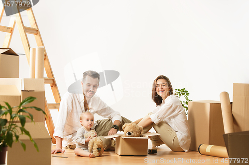 Image of Couple moving to a new home - Happy married people buy a new apartment to start new life together