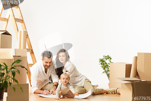 Image of Couple moving to a new home - Happy married people buy a new apartment to start new life together