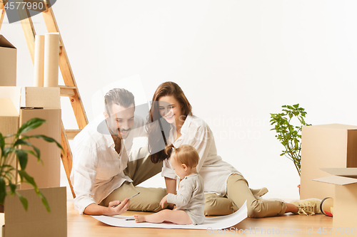 Image of Couple moving to a new home - Happy married people buy a new apartment to start new life together