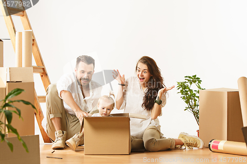 Image of Couple moving to a new home - Happy married people buy a new apartment to start new life together