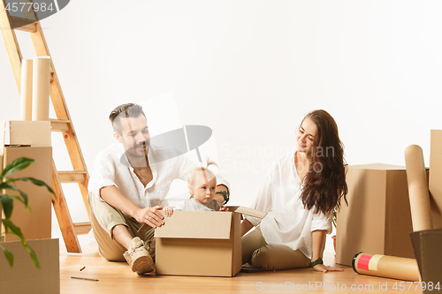 Image of Couple moving to a new home - Happy married people buy a new apartment to start new life together