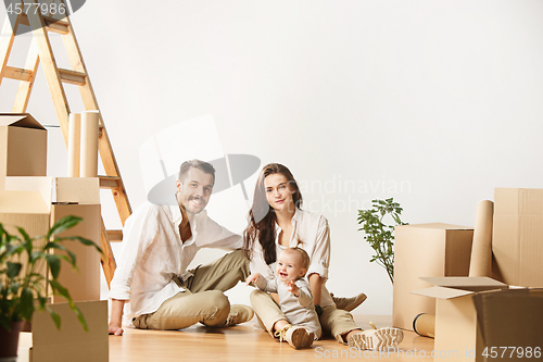 Image of Couple moving to a new home - Happy married people buy a new apartment to start new life together