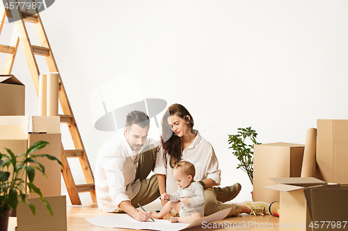 Image of Couple moving to a new home - Happy married people buy a new apartment to start new life together