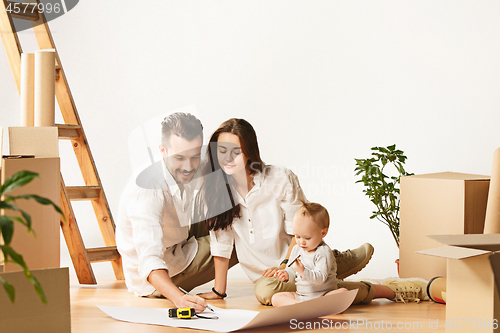 Image of Couple moving to a new home - Happy married people buy a new apartment to start new life together