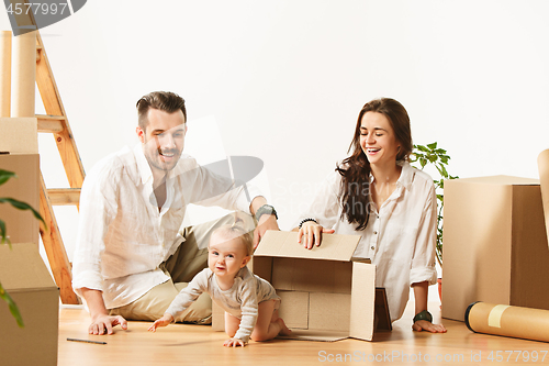 Image of Couple moving to a new home - Happy married people buy a new apartment to start new life together