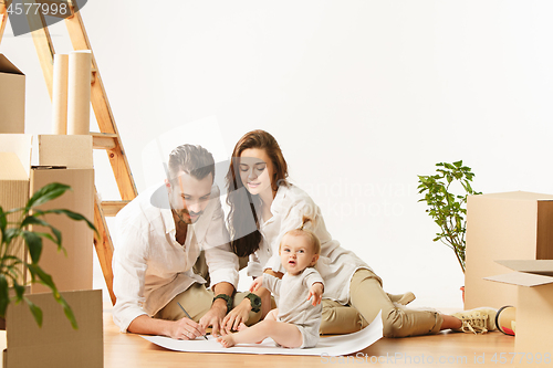 Image of Couple moving to a new home - Happy married people buy a new apartment to start new life together