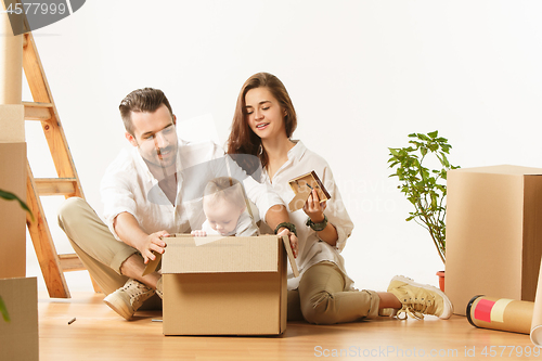 Image of Couple moving to a new home - Happy married people buy a new apartment to start new life together