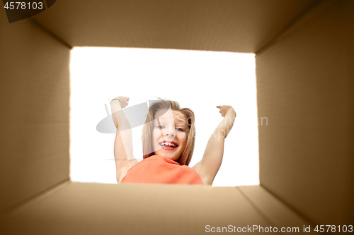Image of happy girl looking into open gift box