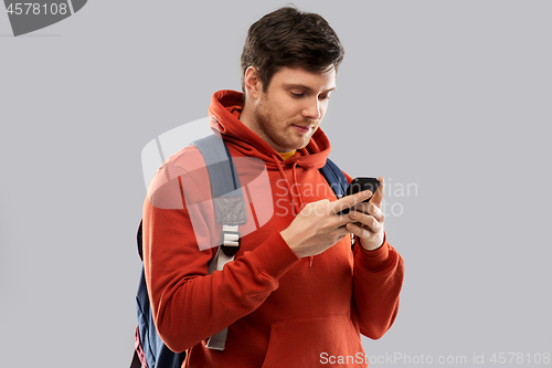 Image of man or student with smartphone and school bag