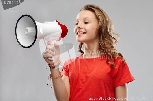 Image of happy teenage girl speaking to megaphone