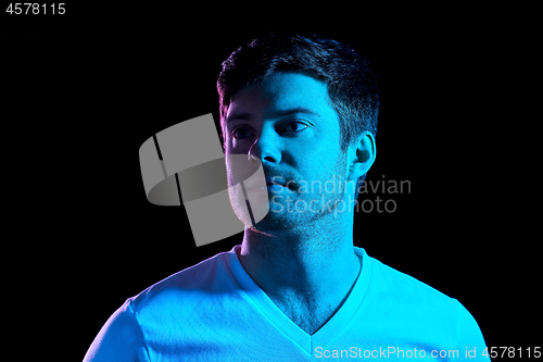 Image of portrait of man over neon lights in dark room