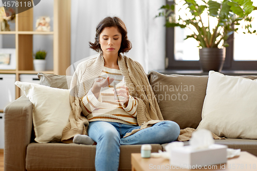 Image of sick woman taking medicine with water at home