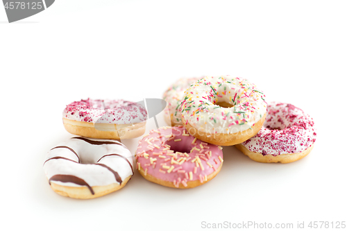 Image of close up of glazed donuts on white table