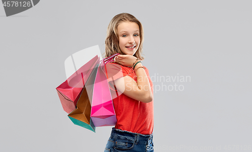 Image of smiling teenage girl with shopping bags