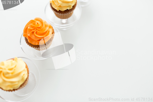 Image of cupcakes with frosting on confectionery stands