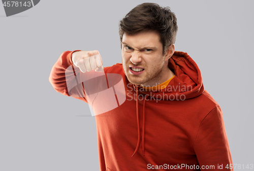 Image of angry young man ready for fist punch