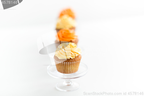 Image of cupcakes with frosting on confectionery stands