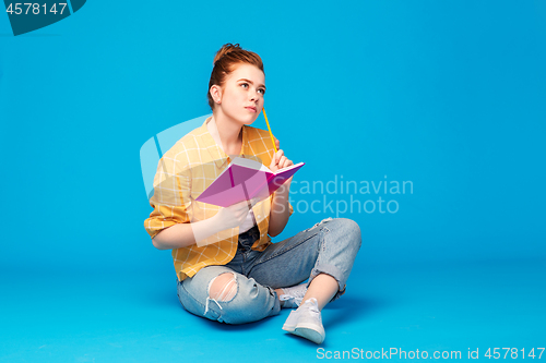 Image of teenage student girl with diary or notebook