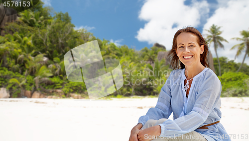 Image of happy woman over seychelles island tropical beach