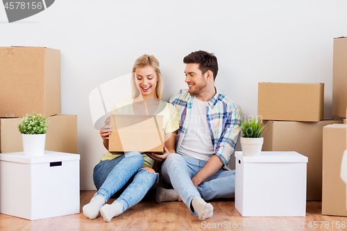 Image of happy couple with boxes moving to new home