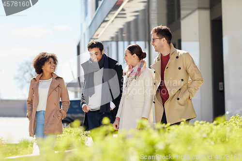 Image of office workers or friends talking on city street