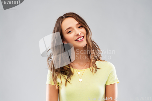 Image of young woman or teenage girl in yellow t-shirt