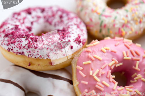 Image of close up of glazed donuts on white table