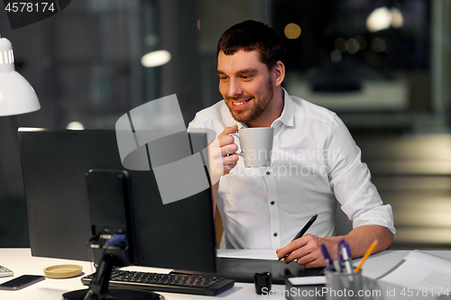 Image of designer with computer and pen tablet at office