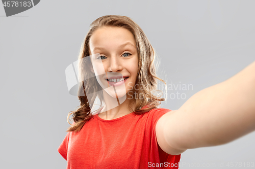 Image of smiling teenage girl taking selfie