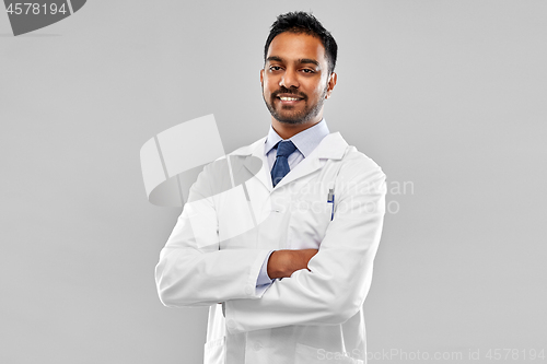 Image of smiling male doctor or scientist in white coat