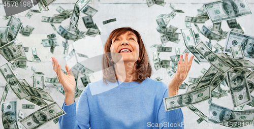 Image of grateful senior woman and money falling from above