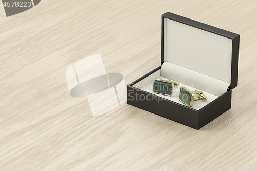 Image of Box with golden cufflinks