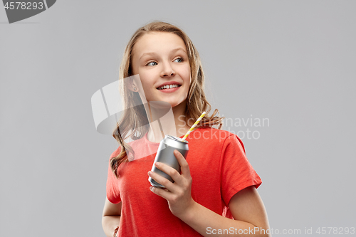 Image of teenage girl holding can of soda with paper straw