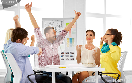 Image of happy creative team or designers at office