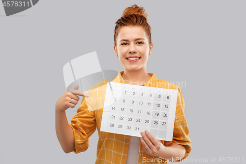 Image of happy red haired teenage girl with calendar sheet